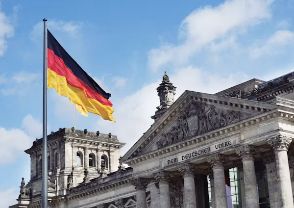 Student walking past historic university architecture in Germany