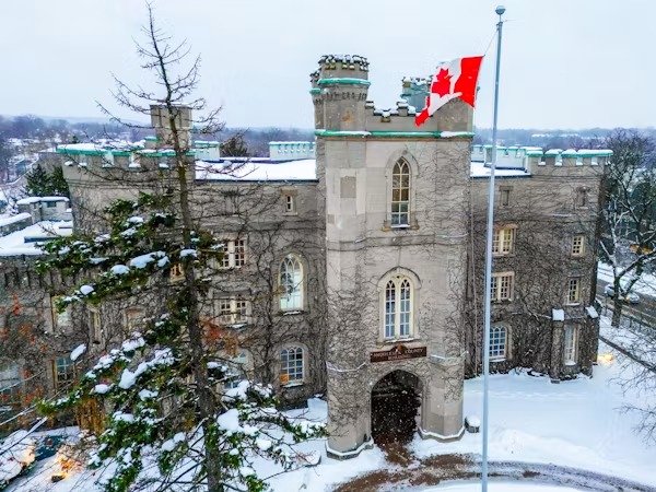International student studying in front of a Canadian university library